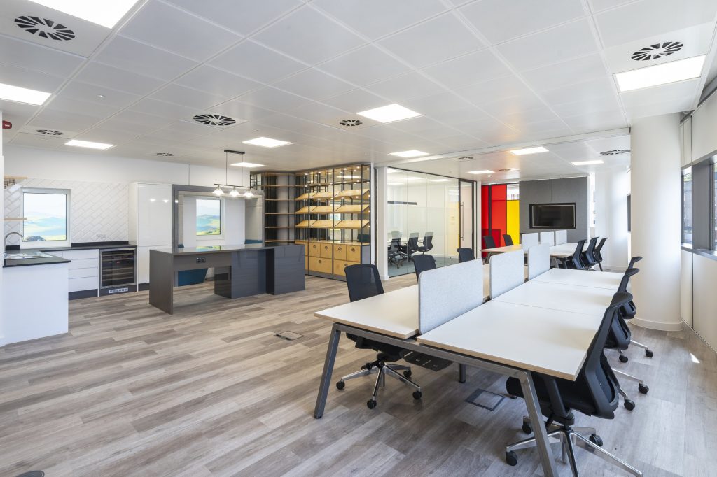 Newly refurbished office space in The Poppy Building, located in Brewhouse Yard, London's Tech Hub, featuring floor-to-ceiling windows and a communal roof terrace.
